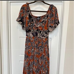 Flowy midi dress with asymmetrical hemline.  Has a small cutout.
